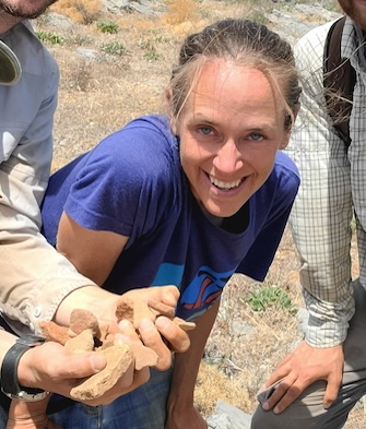 Photo of Sarah Murray leaning over, smiling.