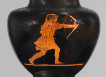 Black terracotta jug with a figure of an archer, drawing a bow.